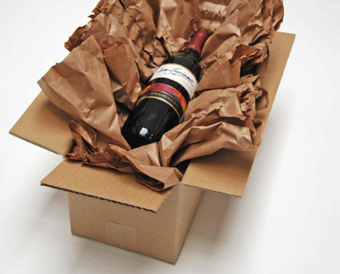 Eine Weinflasche wird in PadPak LC Papier gewickelt.
